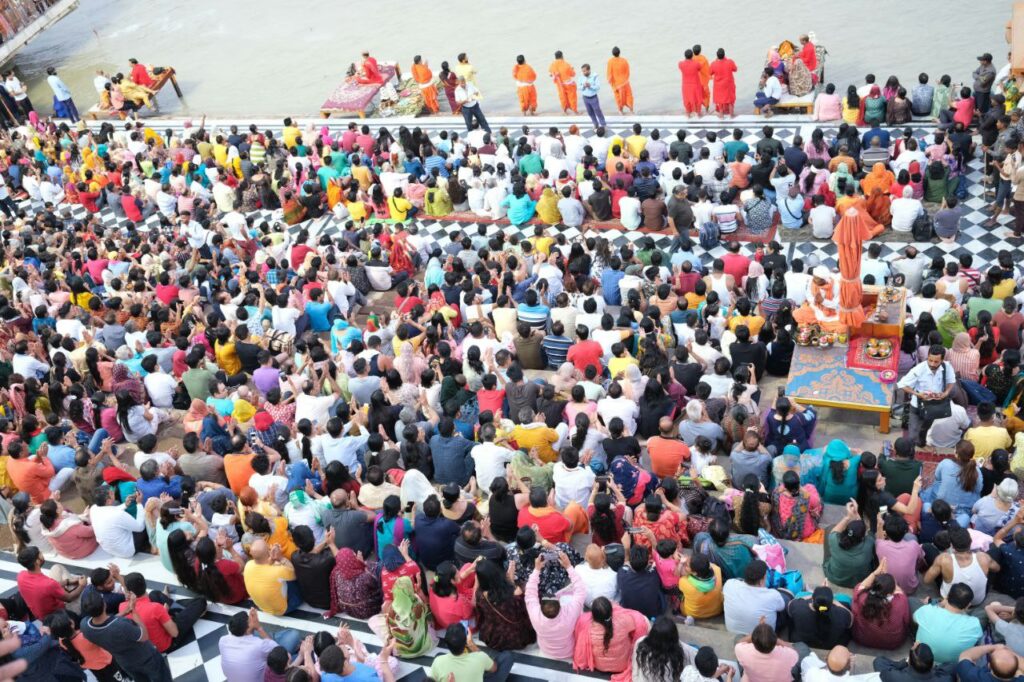 हरिद्वार गंगा आरती - पुजारी बड़े दीपकों के साथ मंत्रोच्चार करते हुए, भक्तों की भीड़