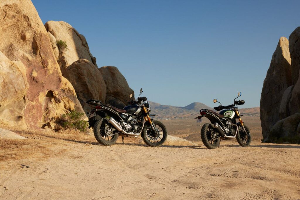 Triumph Scrambler 400 XC riding through rugged mountain trail